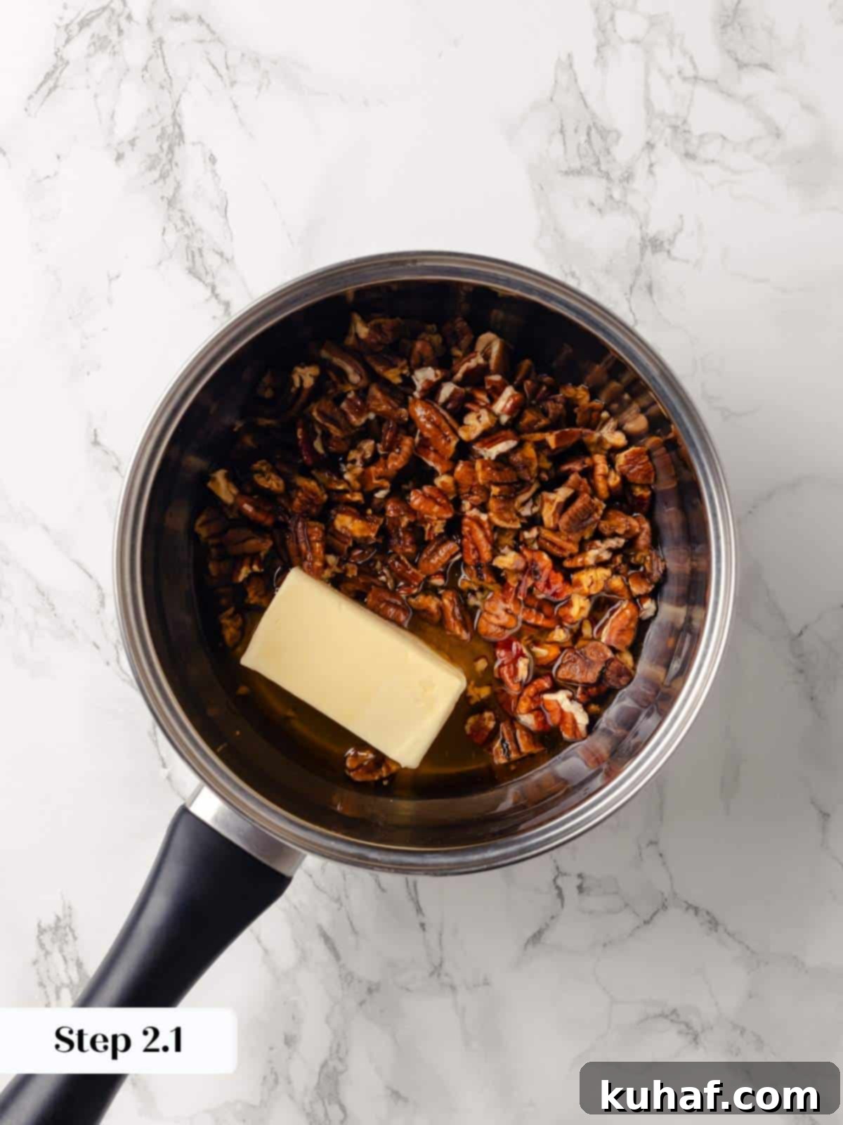 A pot with butter, brown sugar, and pecans melting together.