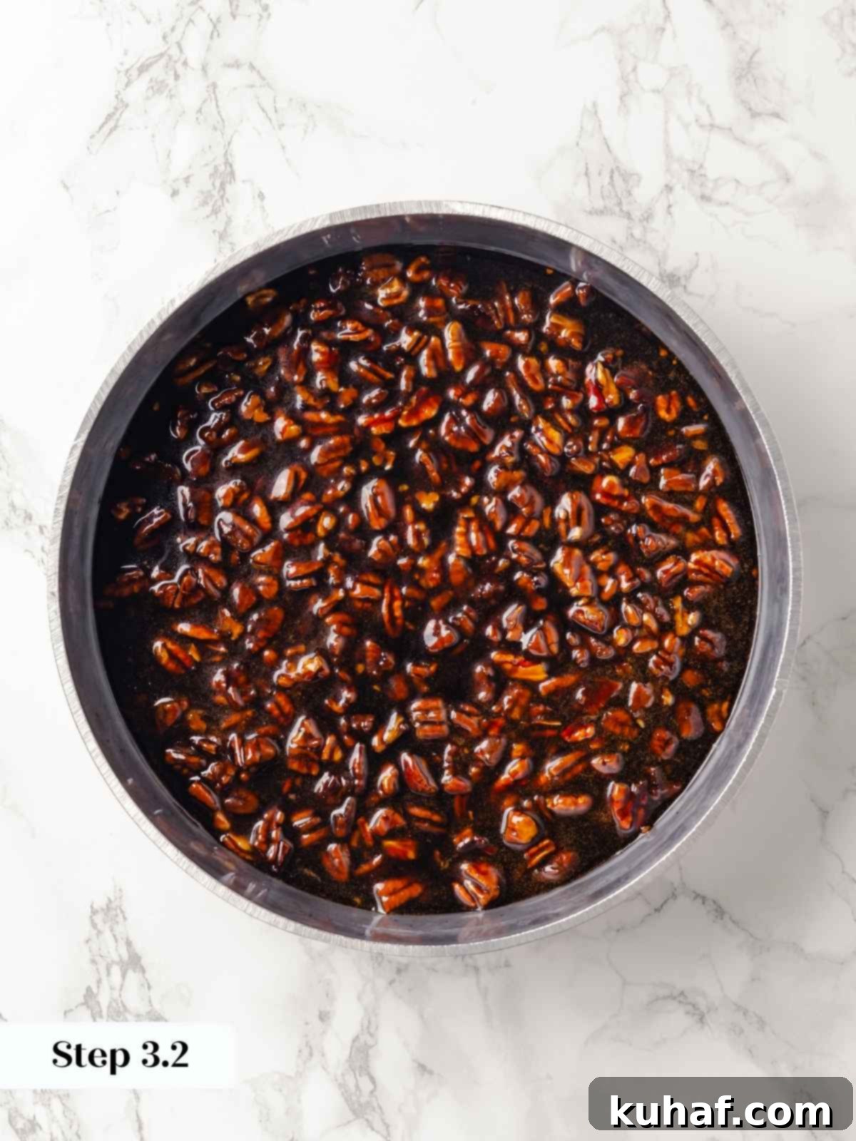 A pan filled with pecans and caramel mixture before baking.