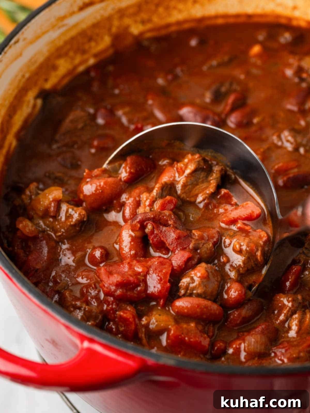 serving chili with ladle.