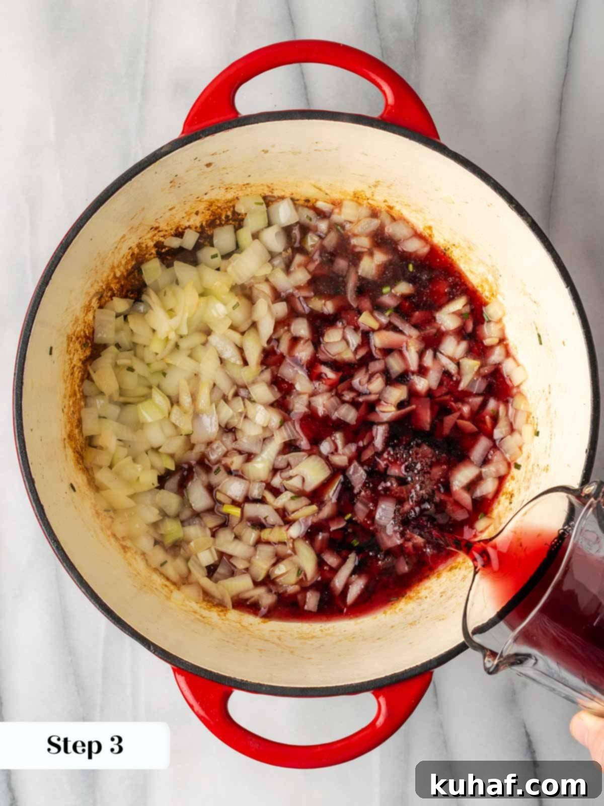 adding red wine to chili pot.
