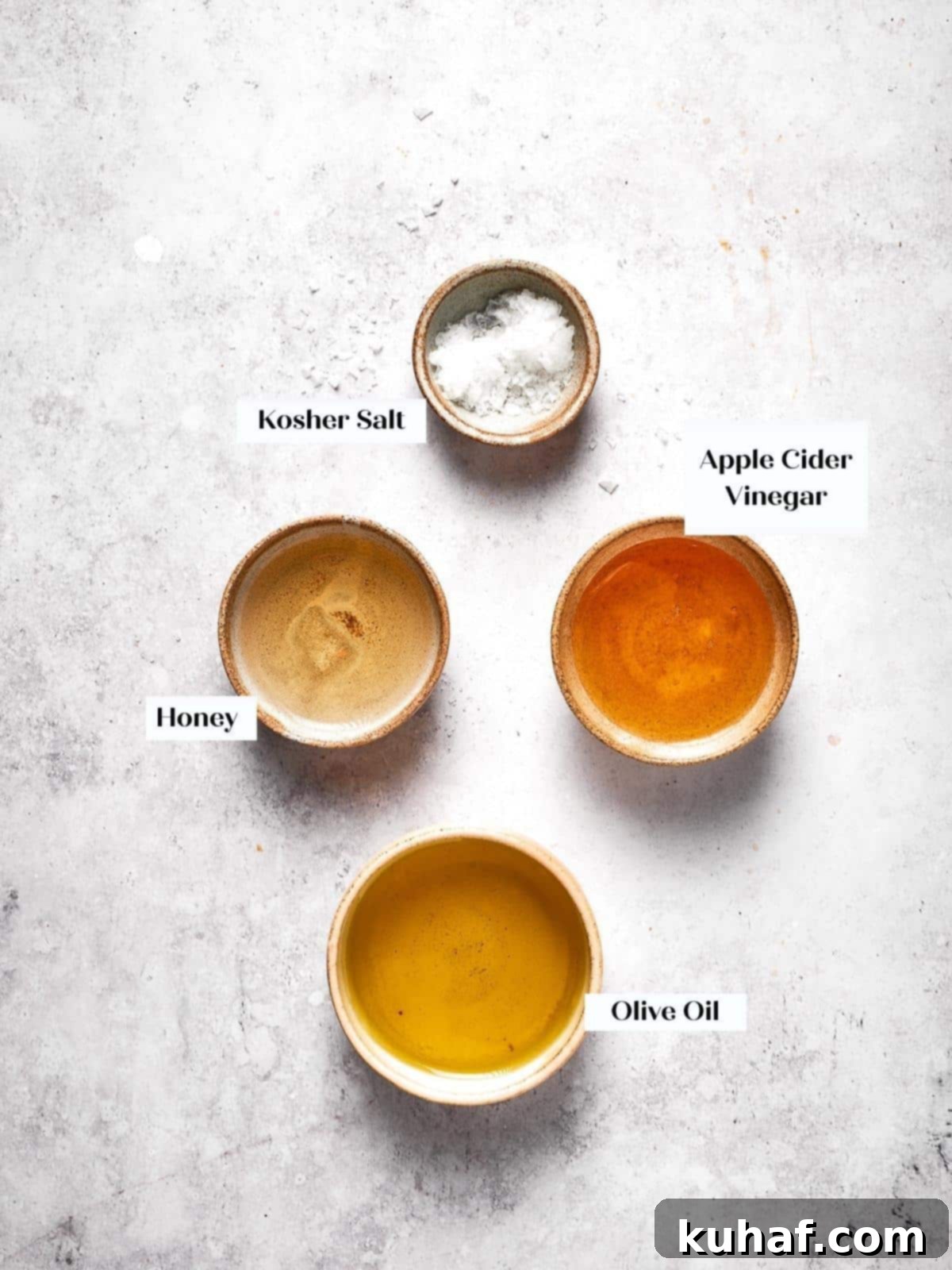 All the fresh ingredients for the homemade apple cider vinaigrette, neatly arranged on a kitchen counter, ready to be combined.