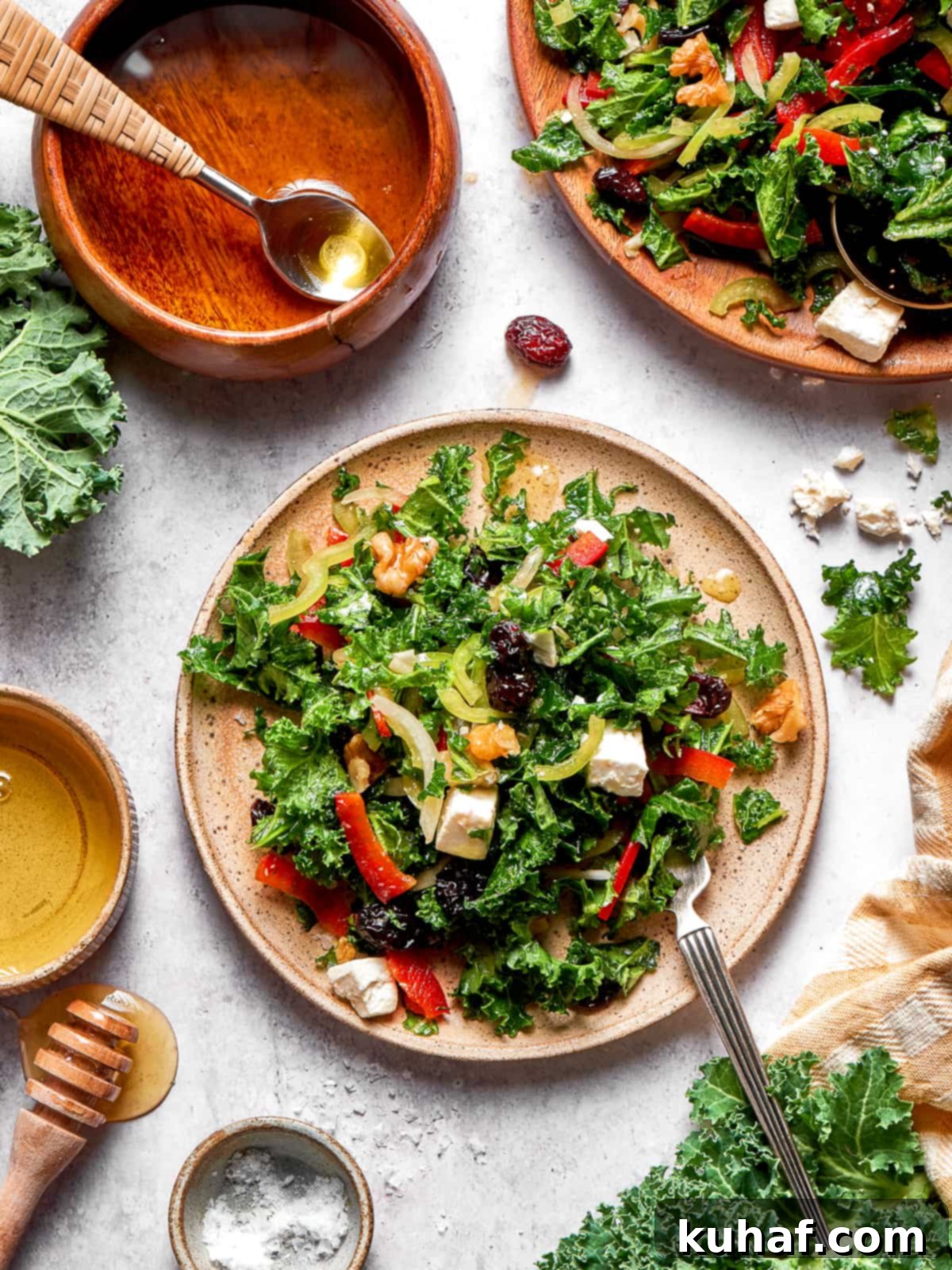A vibrant, freshly prepared kale salad generously plated and ready to be enjoyed, showcasing all its delicious components.