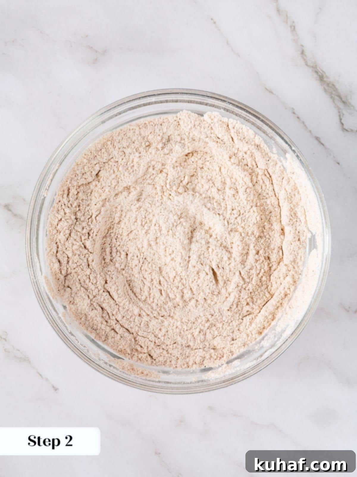 Spiced Carrot Cupcake Bliss 5 Dry ingredients like flour and spices whisked in a bowl.
