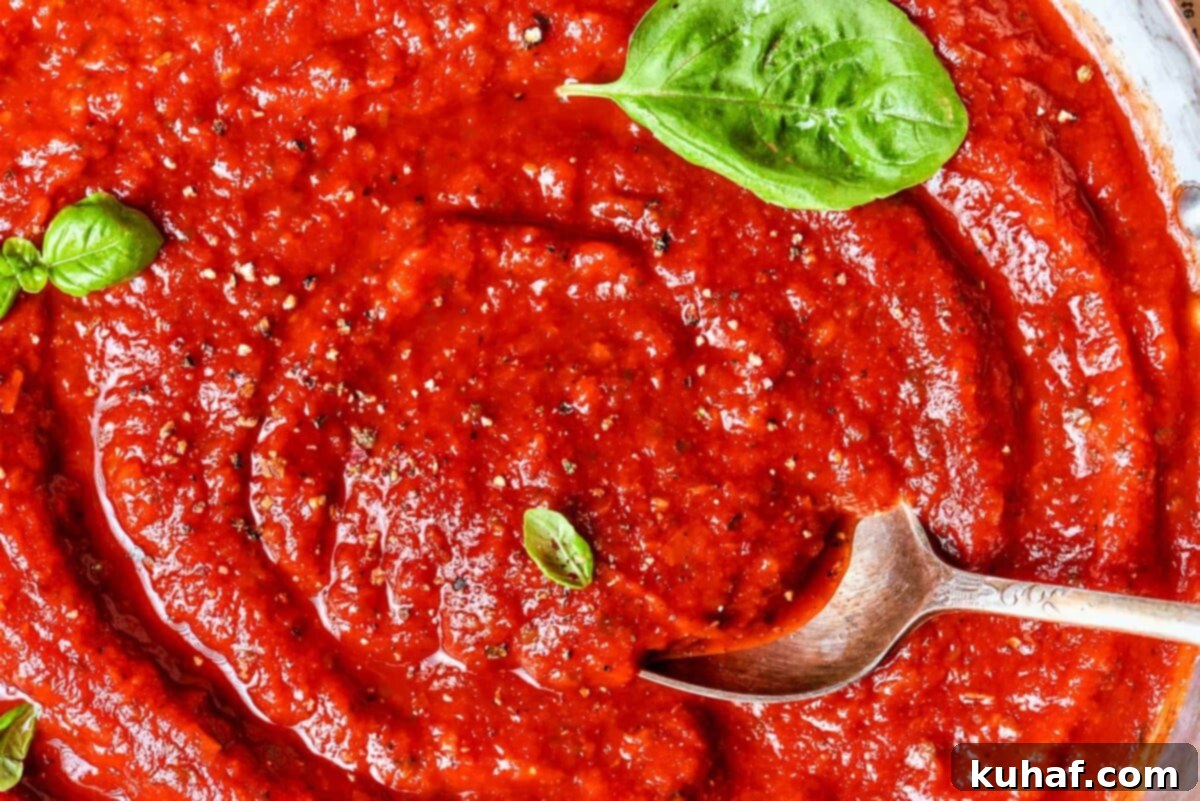 Perfect Homemade Pizza Sauce 3 Glossy tomato sauce with a spiral pattern showing its thickness.