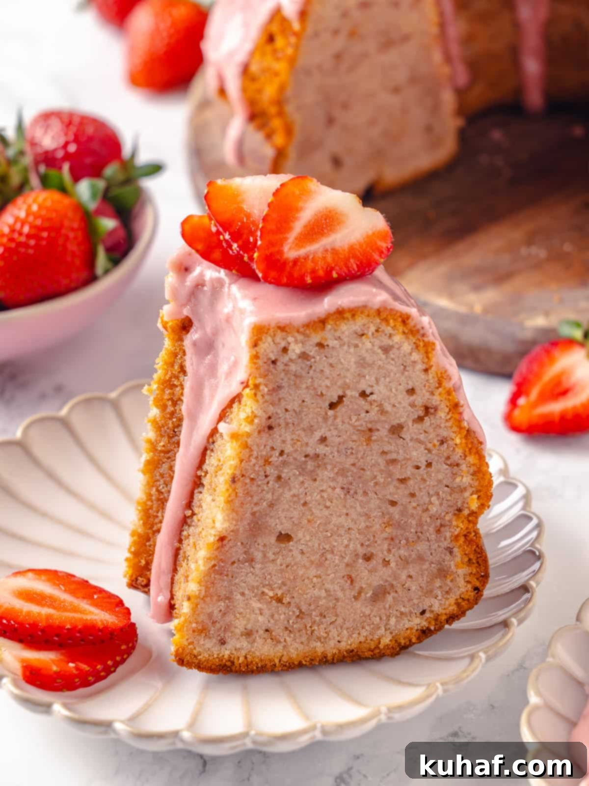 Single slice of strawberry pound cake served with visible glaze drizzle, showcasing its moist texture.
