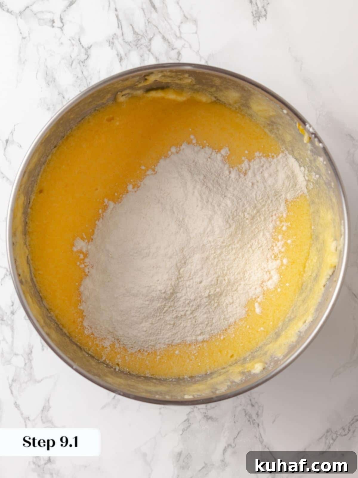 Dry ingredients gradually added to the wet mixture in a large mixing bowl, ensuring even distribution.