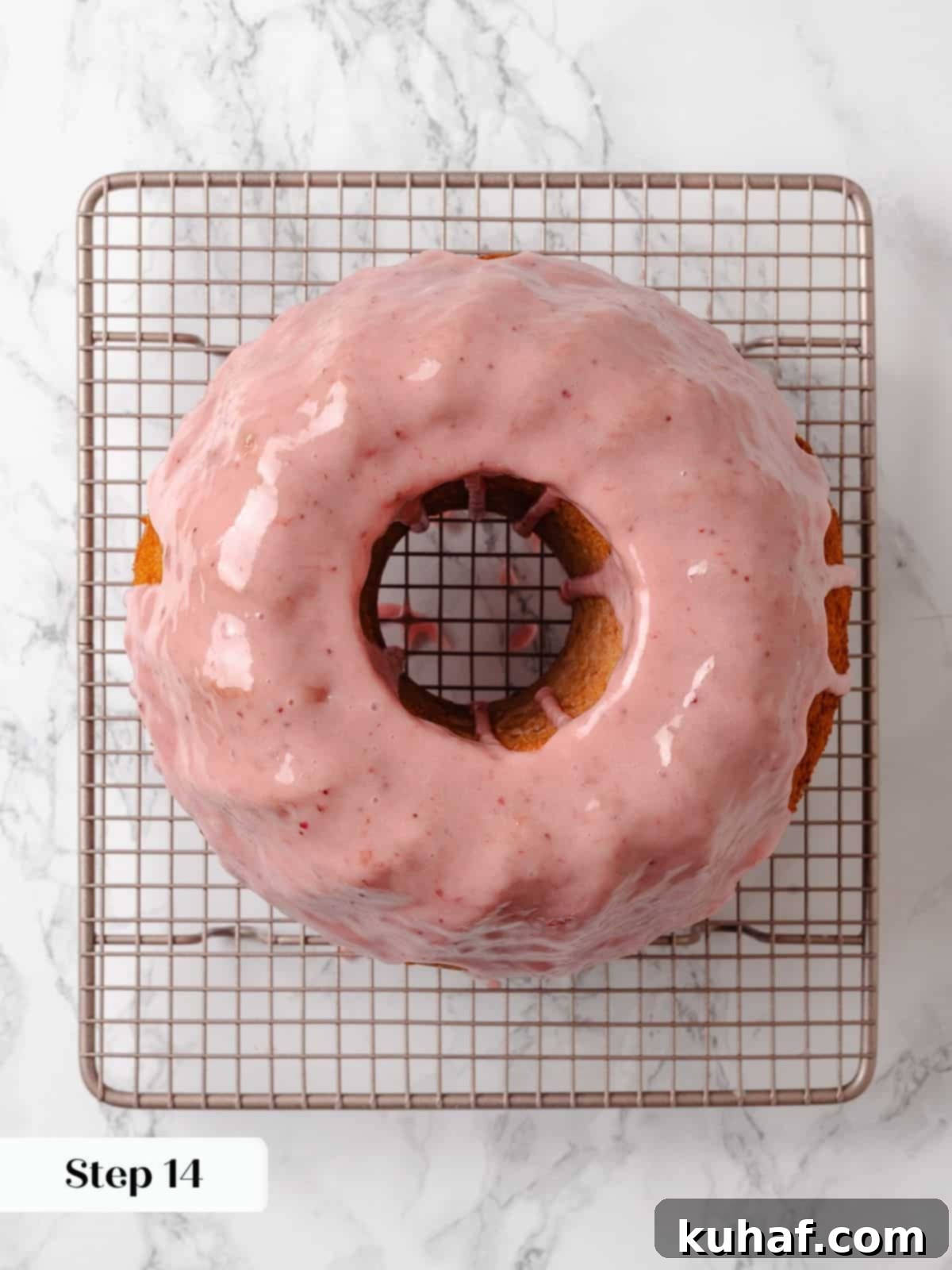 Fully baked pound cake on a wire rack, freshly glazed and allowing the glaze to set and drip.