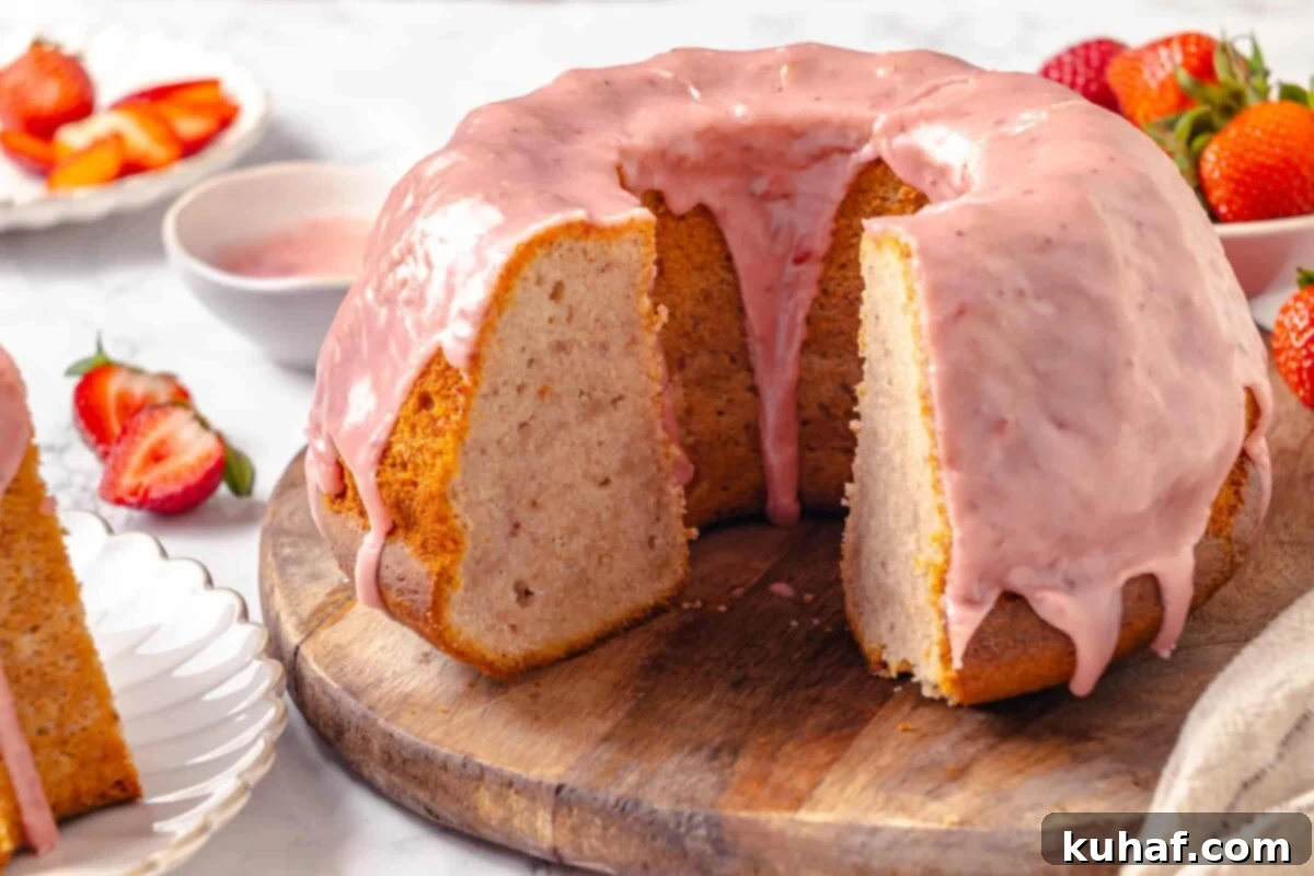 Moist strawberry pound cake sliced open to reveal its soft, buttery interior and tender crumb, showcasing perfect texture.