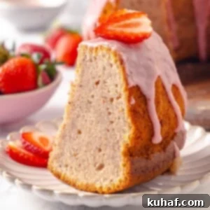 Fresh glaze dripping slowly along the cake’s edges, adding texture and color to the Strawberry Pound Cake.