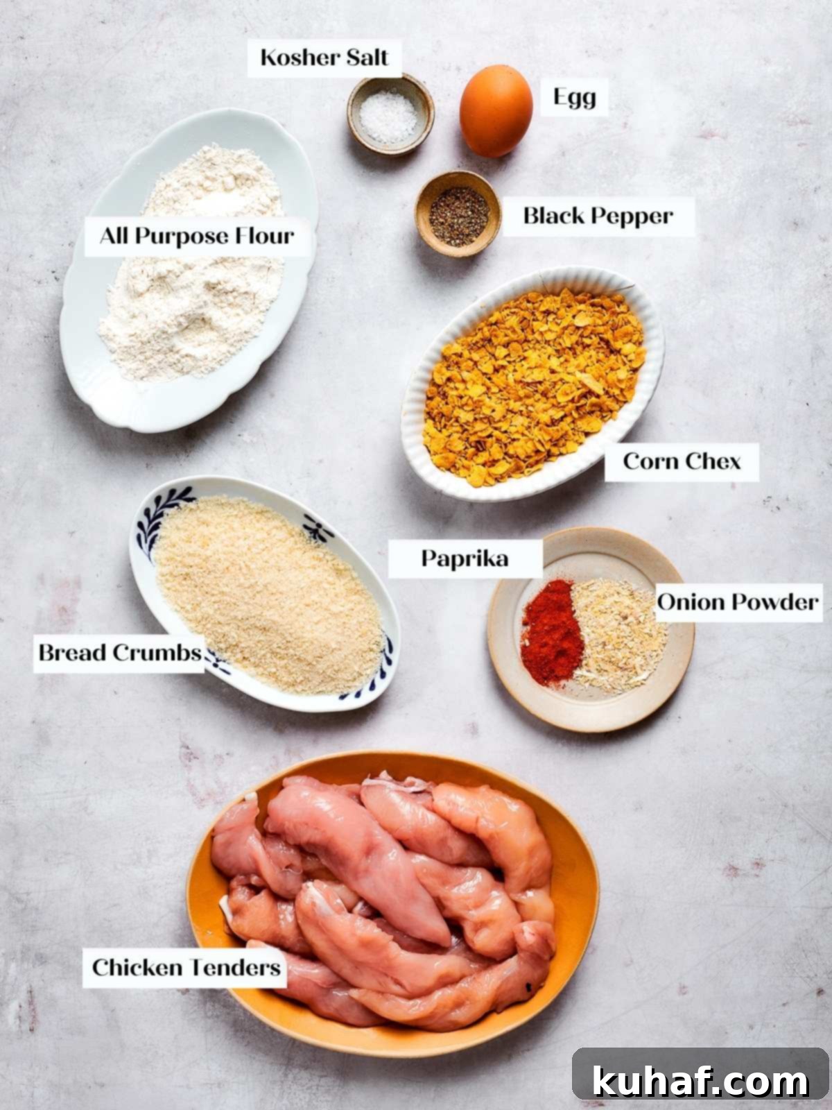 All essential ingredients for making crispy air fryer chicken tenders, neatly laid out on a kitchen countertop, ready for preparation.