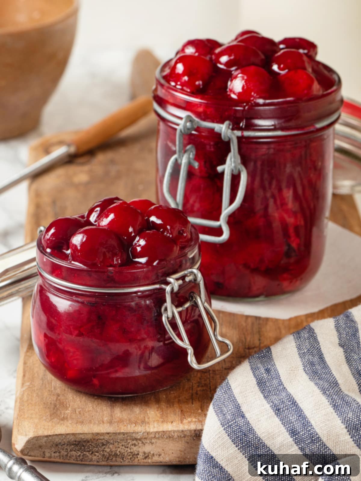 Finished pie filling glows bright red with plump cherries suspended in thick syrup.