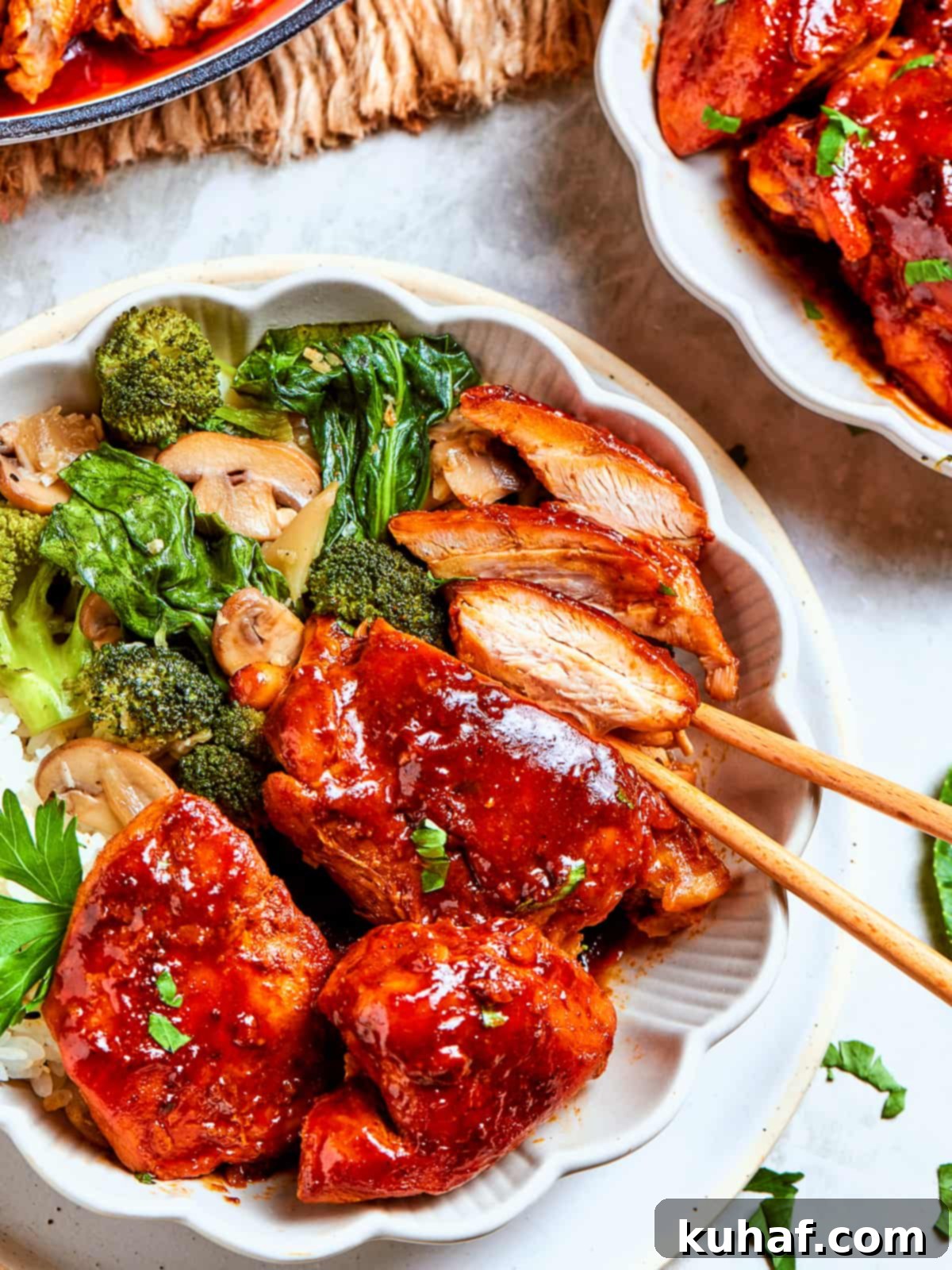 Bright green broccoli florets mingling with sauced chicken and mushrooms in a stir-fry serving, garnished with fresh cilantro.
