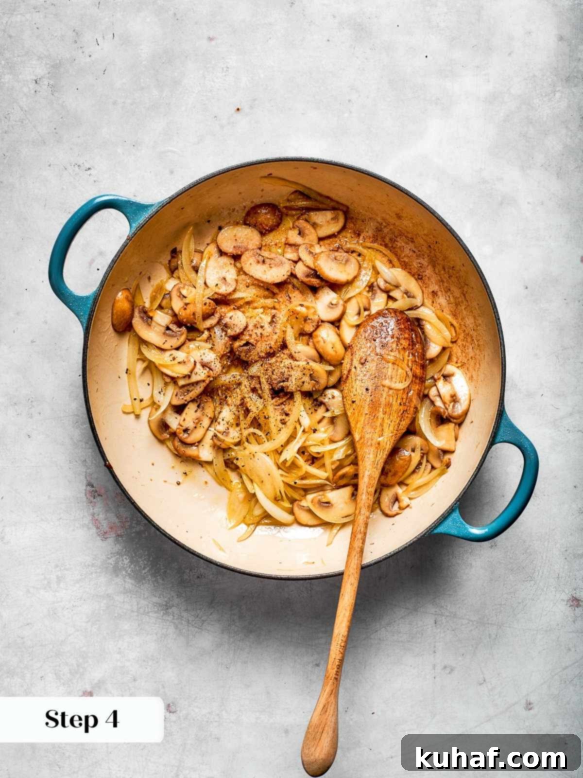 Sautéed onions and mushrooms caramelized to a rich golden-brown in a skillet, creating a fragrant base before the chicken and sauce are added.