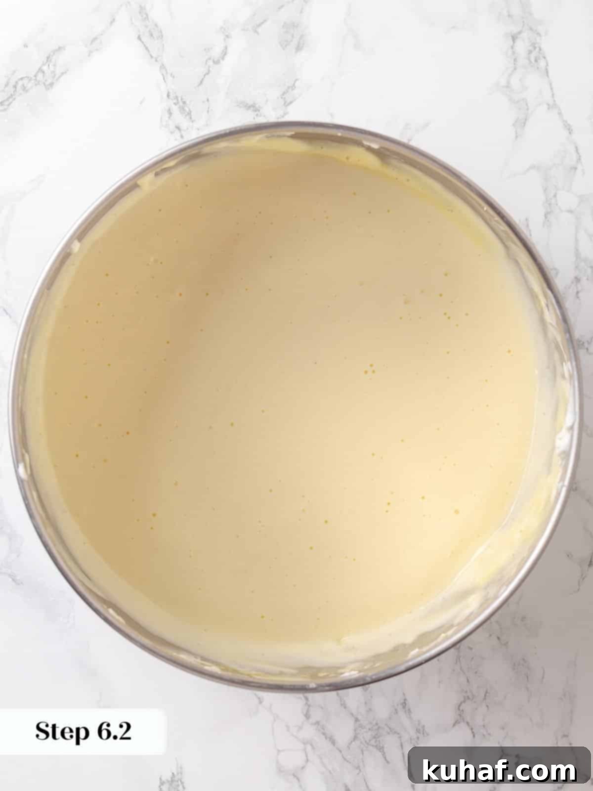 Whole eggs added and mixed into the cream cheese base to form cheesecake filling.