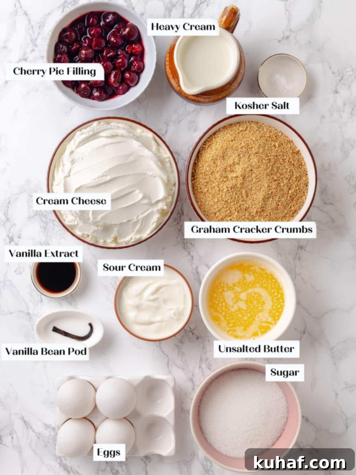 Ingredients laid out before baking cherry cheesecake, including cream cheese, eggs, sugar, and vanilla.