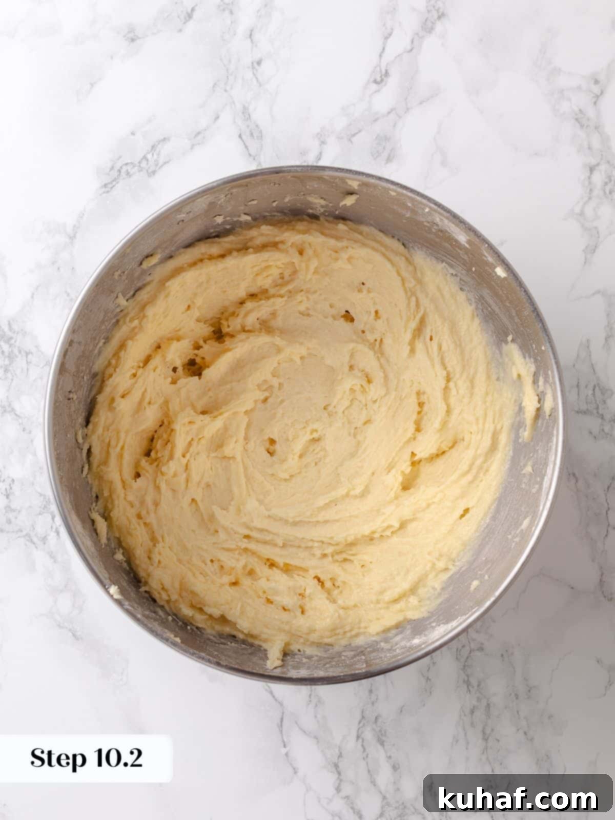 Thick sugar batter is fully mixed and waiting to be spread on the risen cake base.