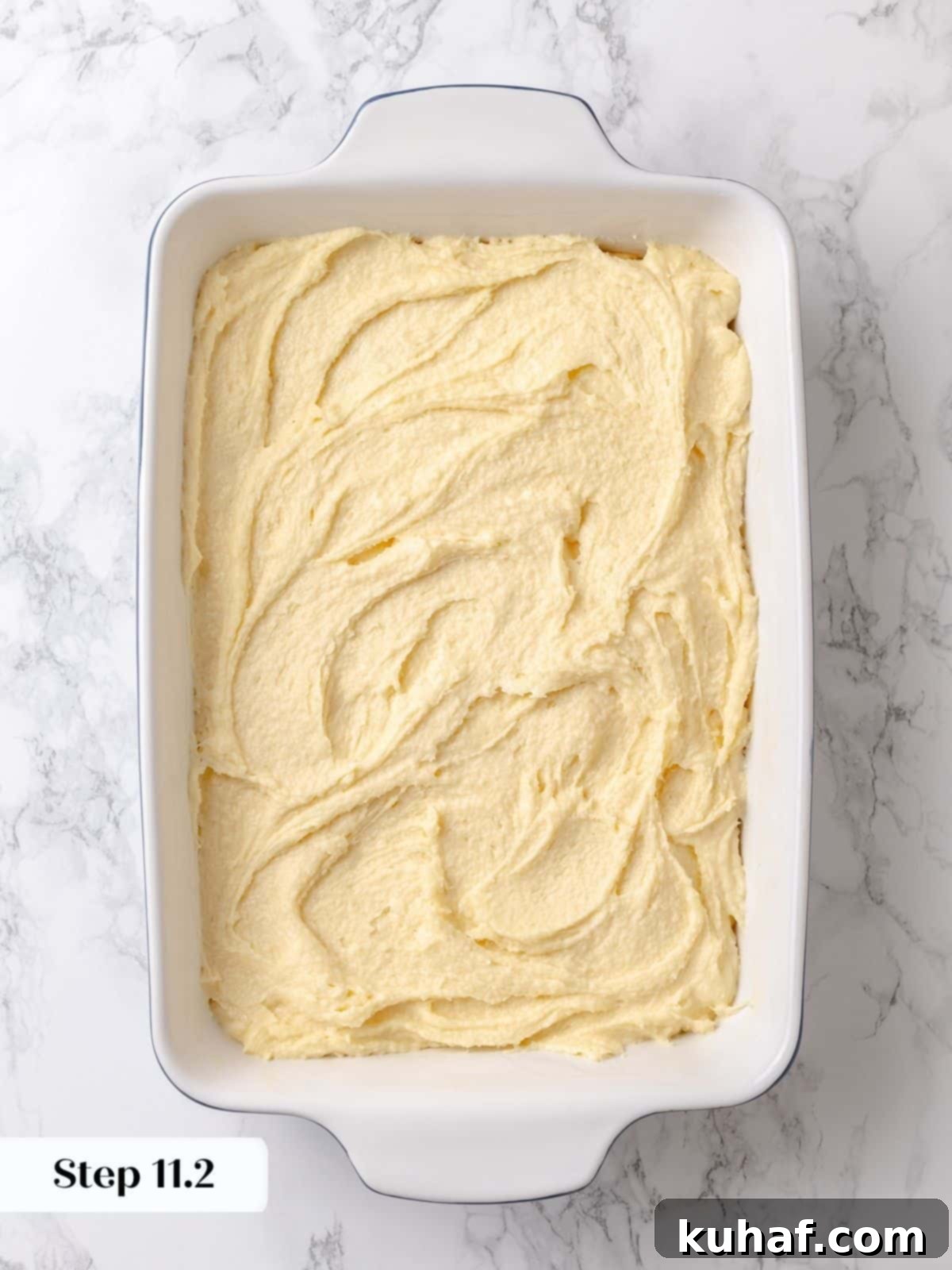 Gooey topping layer fully covers the base, ready to bake into signature texture.