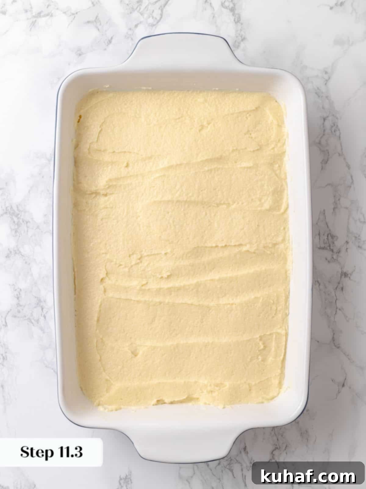 Soft batter spread to edges of the dish before rising and adding the topping.