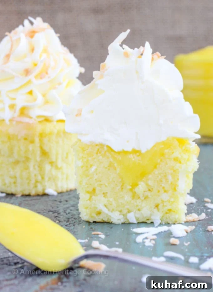 These Lemon Coconut Cupcakes have a moist coconut cake, a sweet, tart lemon curd filling and are topped with a lemon Italian meringue buttercream! 