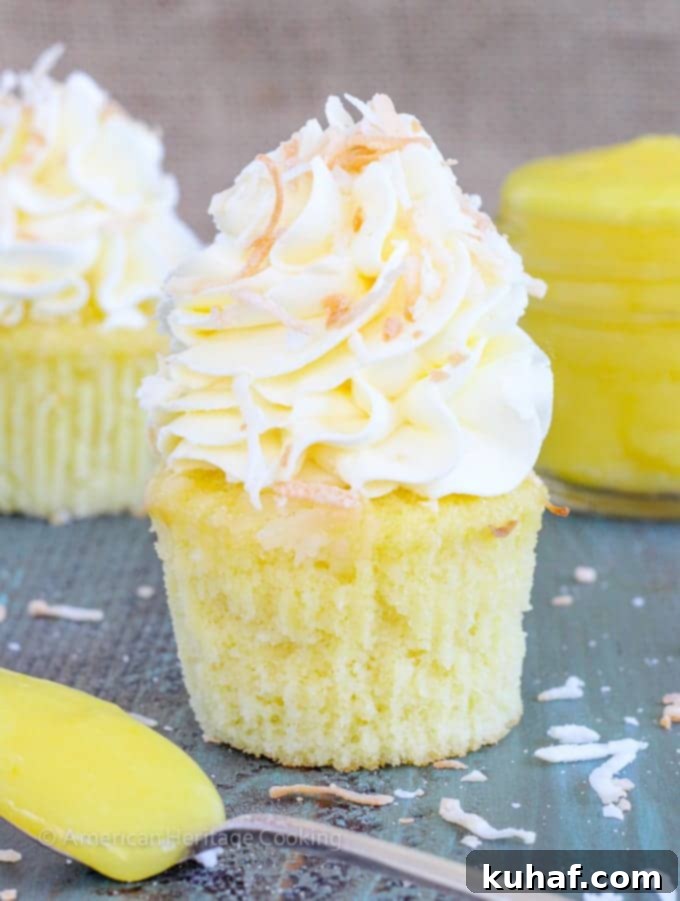 In these Lemon Coconut Cupcakes a moist coconut cupcake that is made with both dried coconut and coconut milk is filled with lemon curd and then topped with a coconut Italian Meringue Buttercream.  And then topped off with some more toasted coconut.