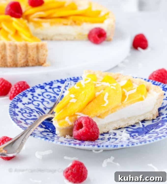 Exotic Mango Coconut Tart 3 Close-up of a slice of Coconut Mango Tart, showcasing the creamy filling and fresh mango layers.