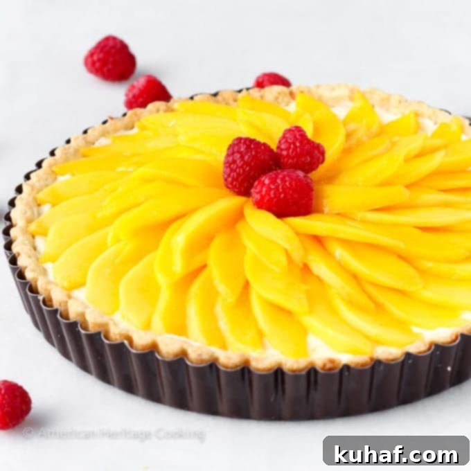 Exotic Mango Coconut Tart 4 Top view of a Coconut Mango Tart featuring a beautiful arrangement of thinly sliced mangoes.