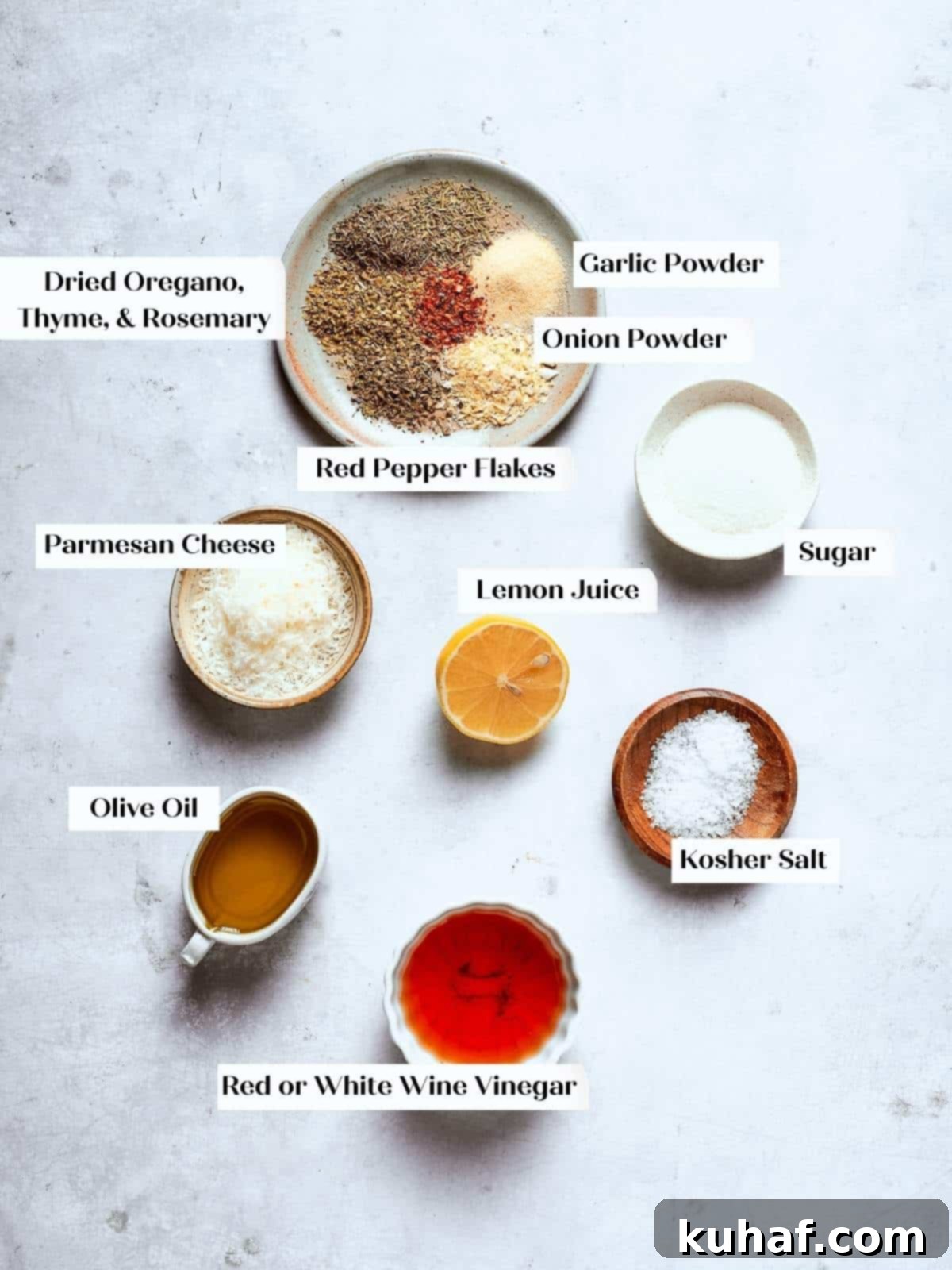Ingredients for Italian salad dressing arranged neatly on a countertop, including bottles of olive oil, vinegar, and small bowls of dried spices.