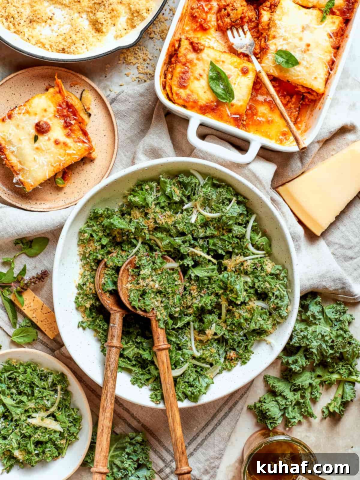 Tuscan kale salad plated next to baked lasagna for a colorful, balanced Italian meal.