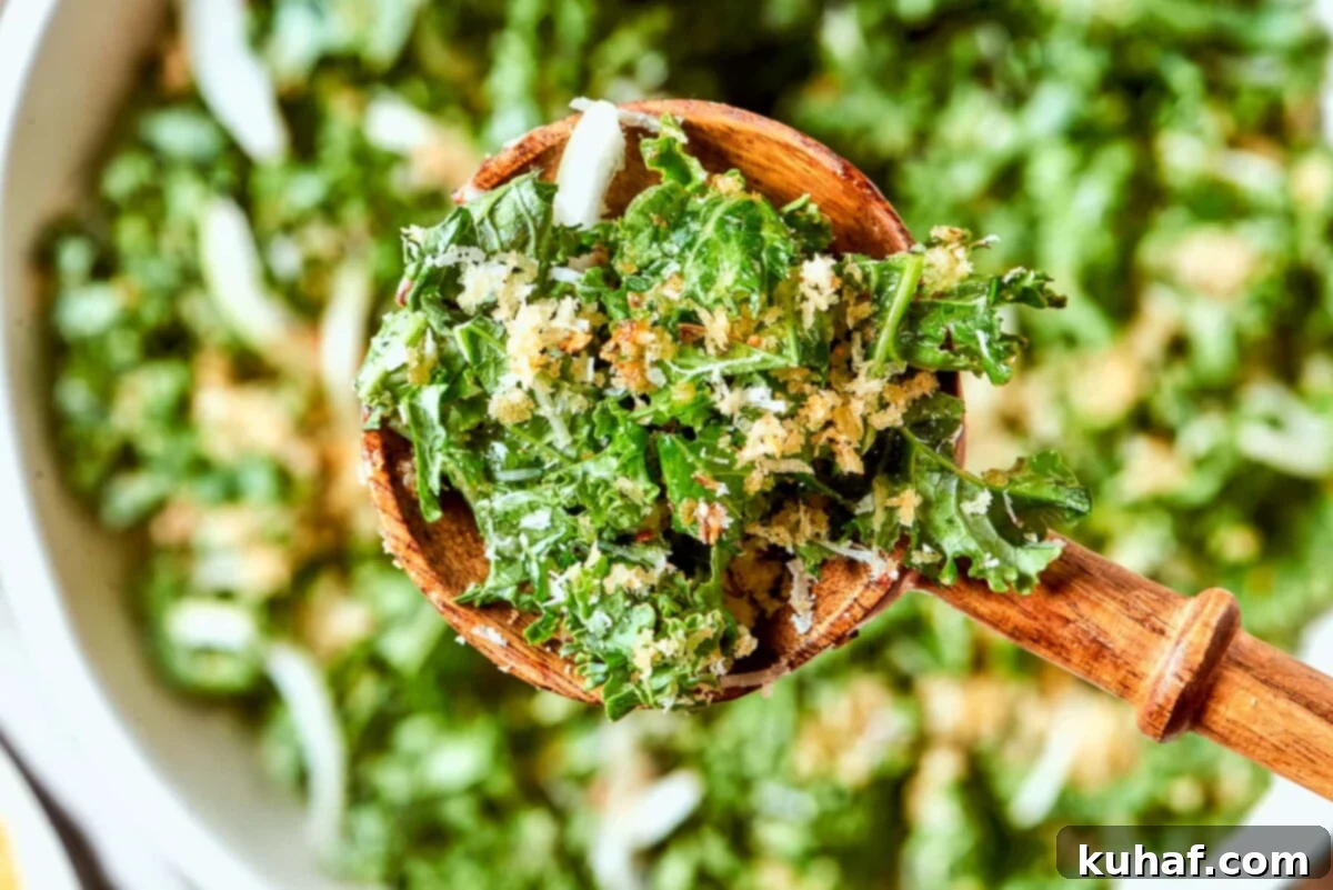 Sliced onion pieces visible throughout Tuscan kale salad with kale ribbons and breadcrumbs.