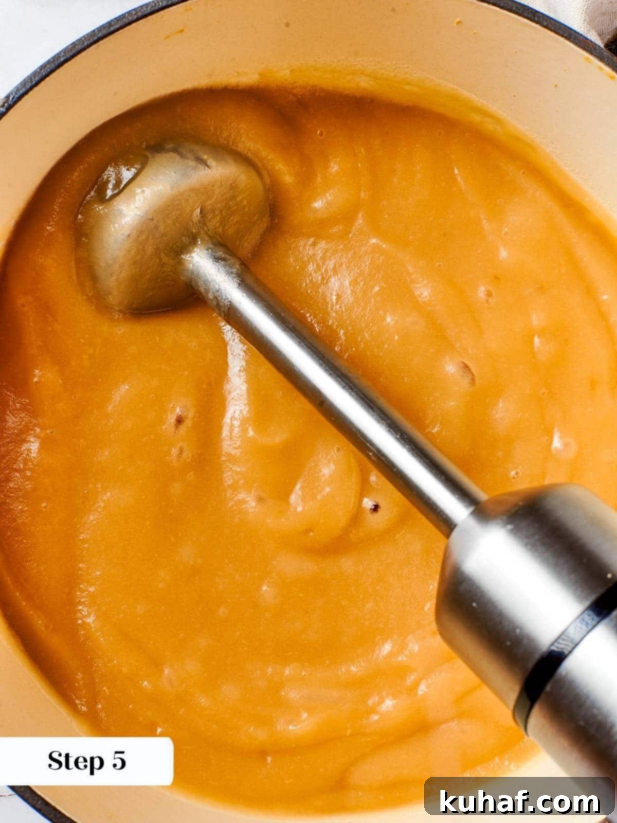 Easy 2 Ingredient Applesauce 7 Using an immersion blender to puree cooked apples directly in the pot to achieve smooth applesauce.