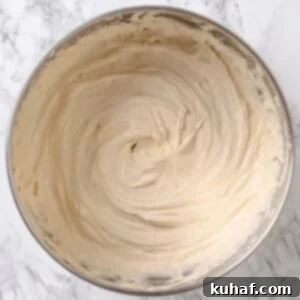 Golden Maple Frosting 12 Maple frosting finished in a mixing bowl, fluffy texture with visible swirls.