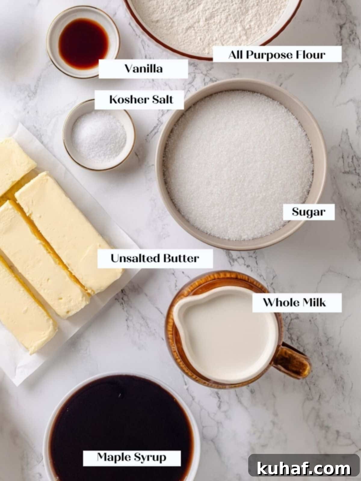 Golden Maple Frosting 3 A selection of maple frosting ingredients including flour, sugar, milk, and real maple syrup are neatly arranged on a kitchen countertop.