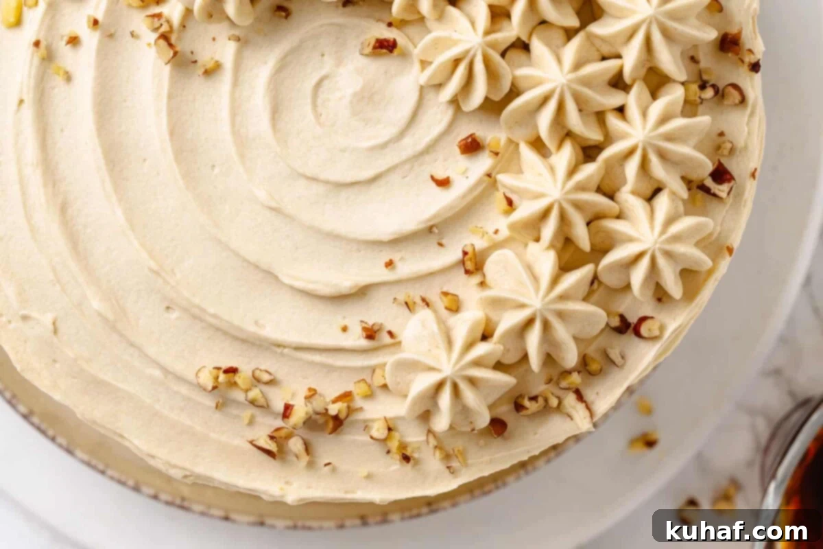 Golden Maple Frosting 4 A festive cake adorned with generous swirls of maple frosting and a sprinkle of chopped nuts, perfect for adding crunch to creamy layers.
