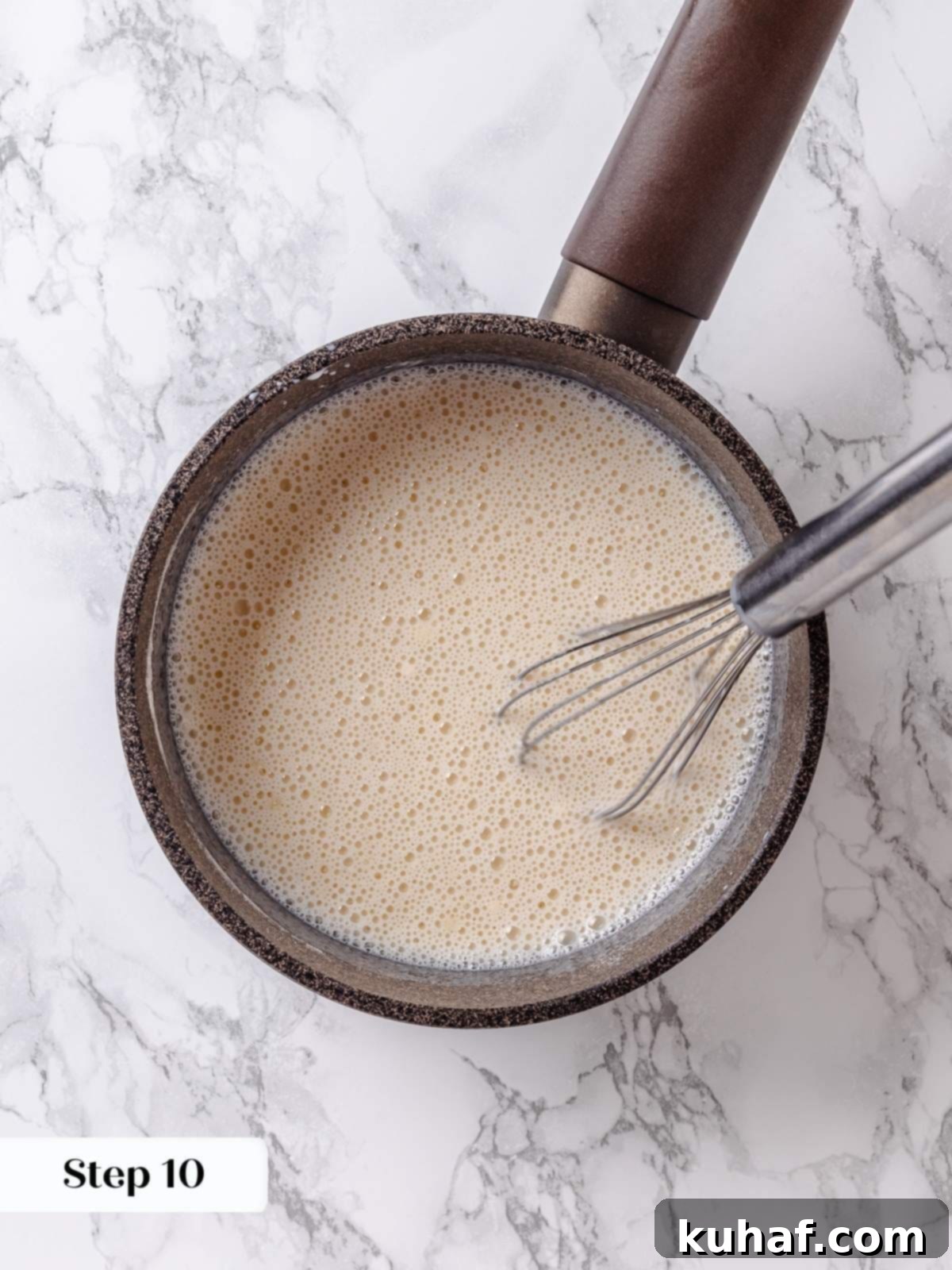 Pure Maple Indulgence 13 Whisk stirring whole milk gradually into the dry flour and sugar mixture in a saucepan to create a smooth, lump-free frosting base.