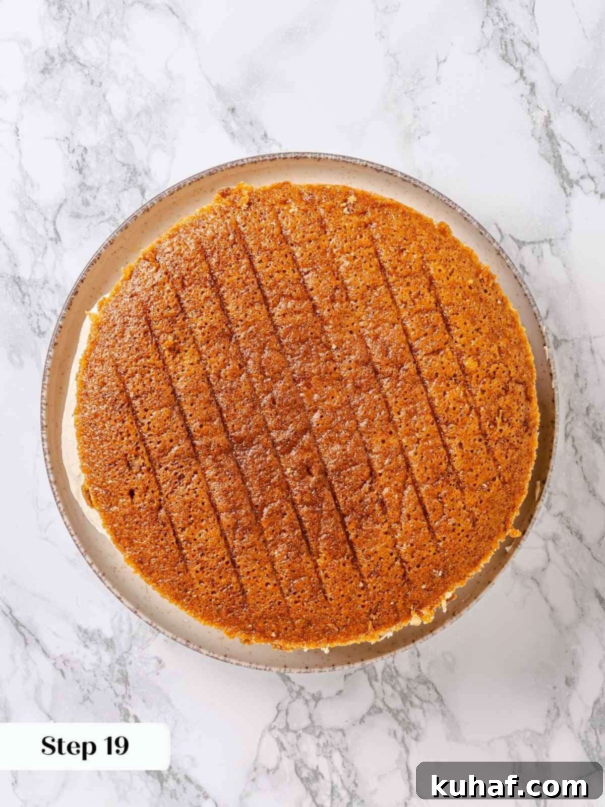 Pure Maple Indulgence 17 Second maple cake layer carefully placed on top of the crumb-coated first layer and frosting, ready for further decoration.