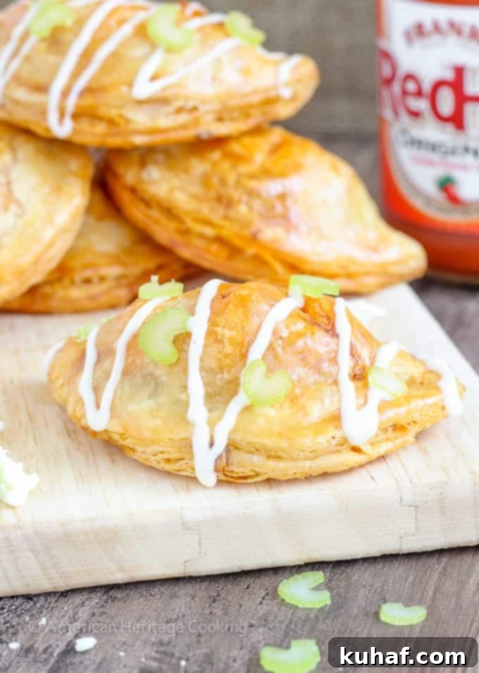 Golden-brown Buffalo Chicken Blue Cheese Hand Pies artfully arranged on a serving board, promising delicious flavor.