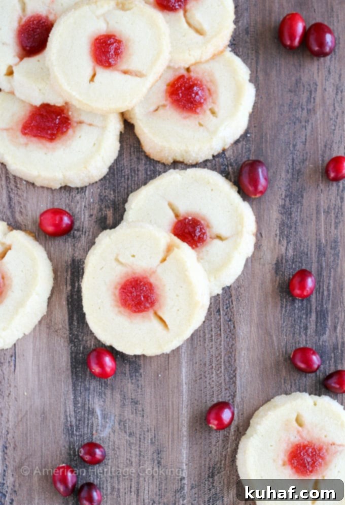 These Cranberry Thumbprint Cookies are a buttery shortbread cookie dough filled with a Moscato cranberry jam and baked to soft, tender perfection. 
