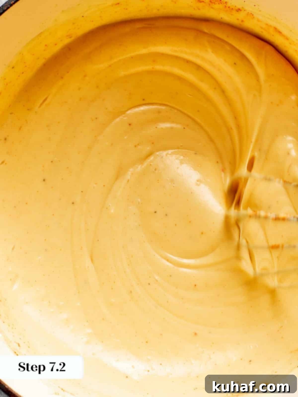 The smooth, golden roux has achieved a perfect, thick consistency, ready for the cheese and seasonings.