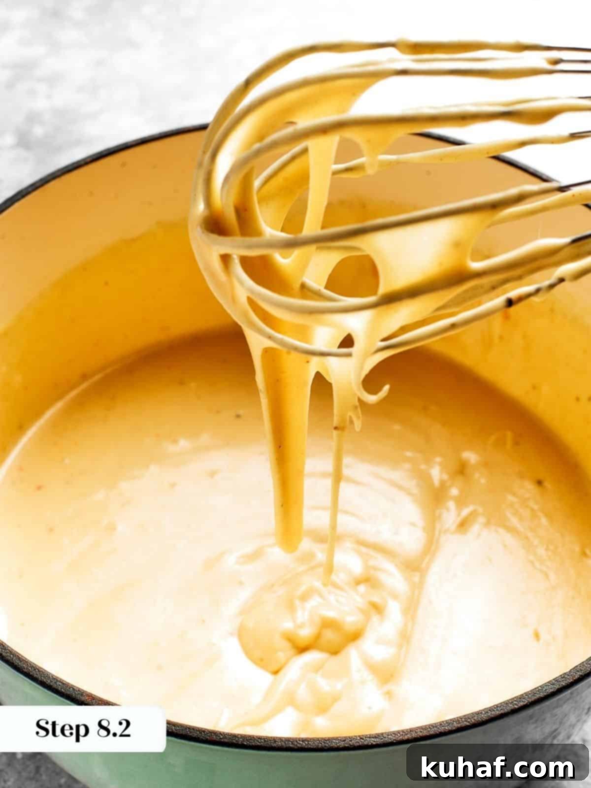 A rich, perfectly blended cheese sauce, seasoned with spices, ready to be combined with the pasta for mac and cheese.