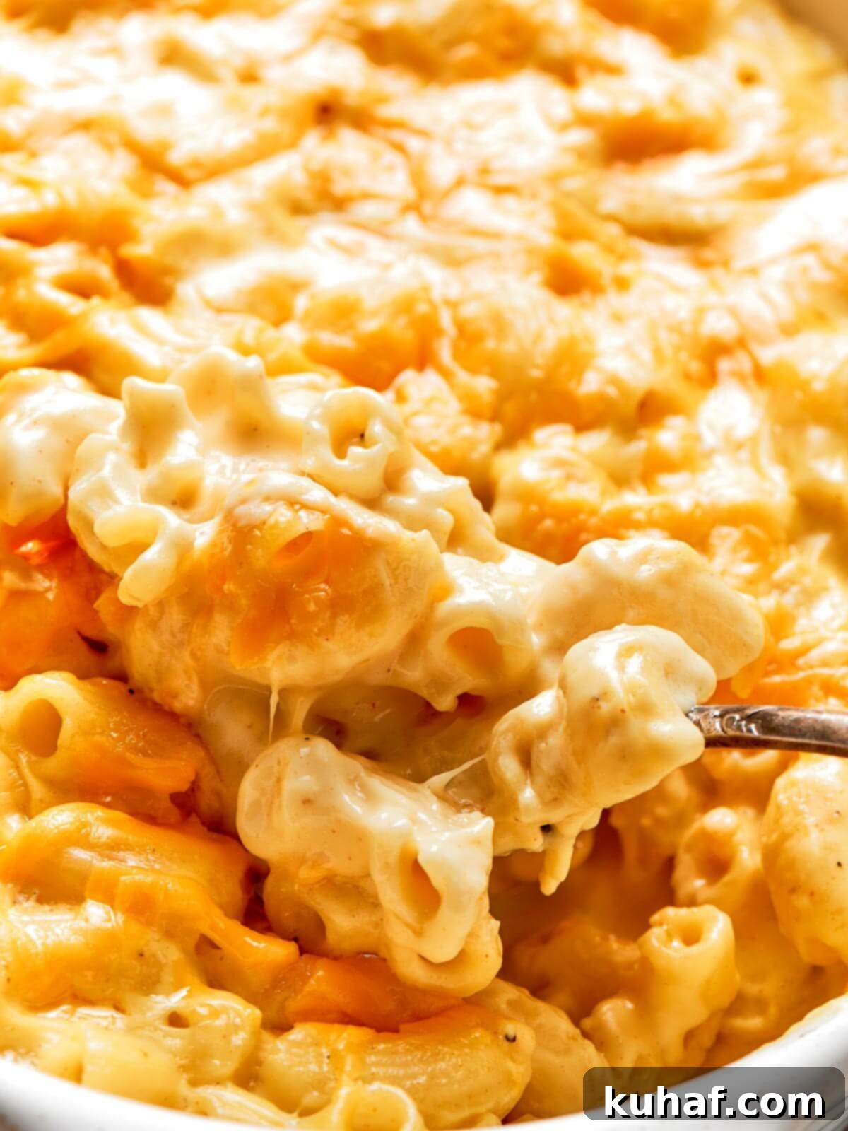 A gorgeous, bubbling dish of baked mac and cheese, fresh from the oven, with a perfectly golden and slightly crispy top.