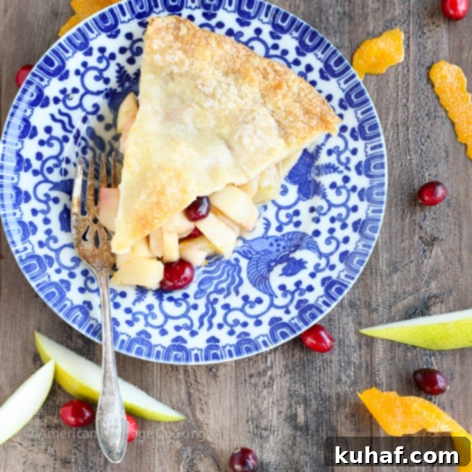A warm, inviting Cranberry Orange Pear Pie, ready to be served, perfect for holiday gatherings or a comforting treat.