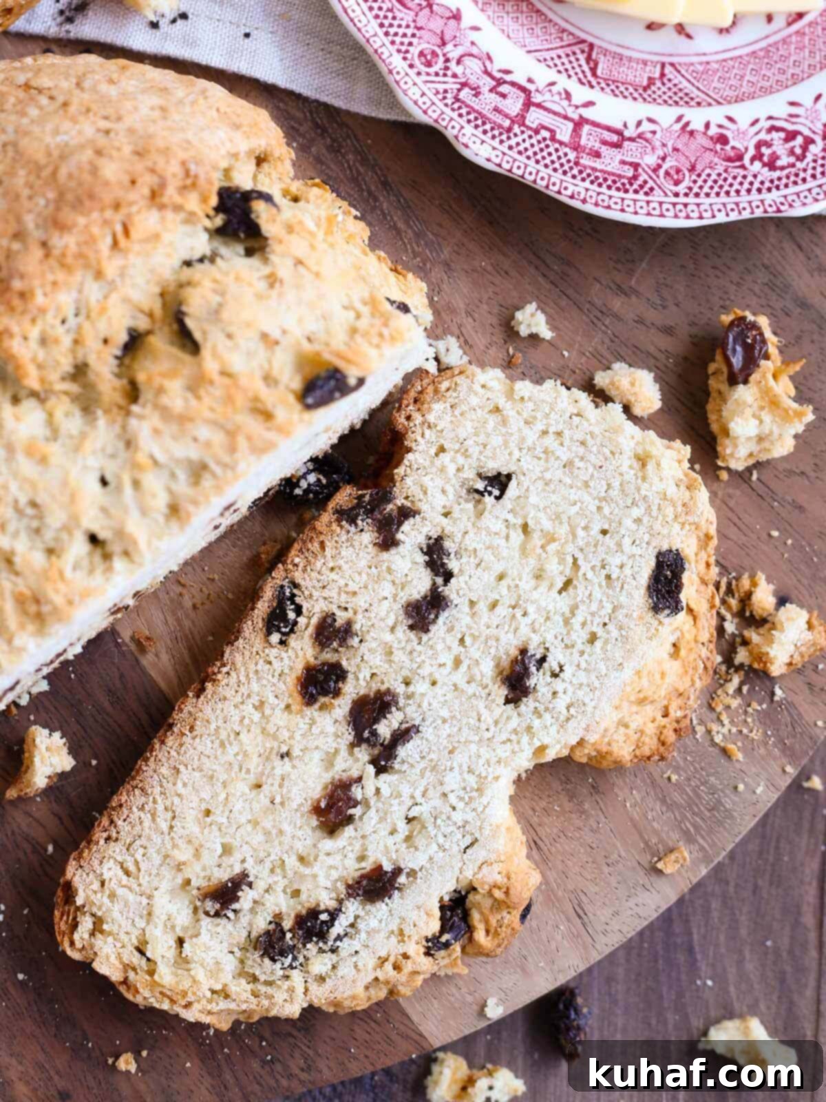 Classic Irish Soda Bread with Sweet Raisins 3 A perfectly sliced piece of traditional Irish soda bread with visible raisins and a tender crumb.
