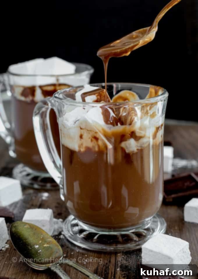 Decadent Hot Chocolate Bliss 8 A generous topping of fluffy homemade marshmallows melting into a mug of the Best Hot Chocolate, creating a luxurious and inviting scene.