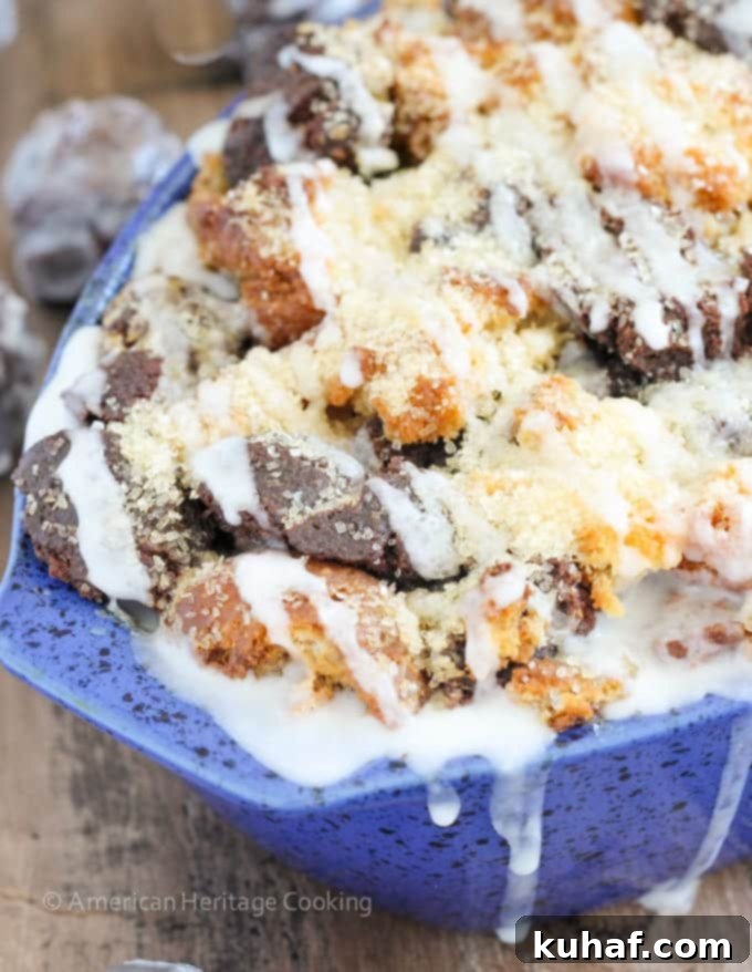 This Coffee Donut Bread Pudding takes everything you love about breakfast and bakes it into one easy dish! Cake donuts baked in a coffee custard for the perfect addition to brunch! A close-up shot of the bread pudding, showcasing its golden-brown top and gooey interior.