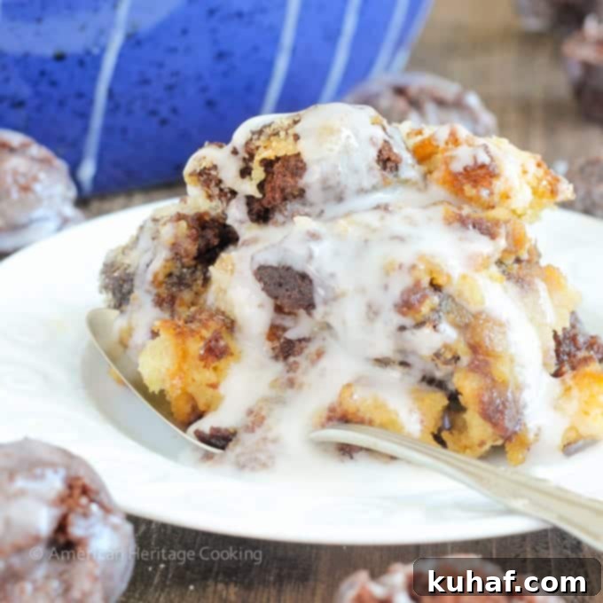 This Coffee Donut Bread Pudding takes everything you love about breakfast and bakes it into one easy dish! Cake donuts baked in a coffee custard for the perfect addition to brunch! A close-up of a single serving of coffee donut bread pudding, with a spoon digging in.