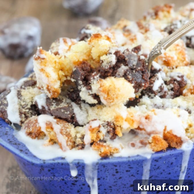 This Coffee Donut Bread Pudding takes everything you love about breakfast and bakes it into one easy dish! Cake donuts baked in a coffee custard for the perfect addition to brunch! A top-down view of the bread pudding in a baking dish, garnished with glaze.