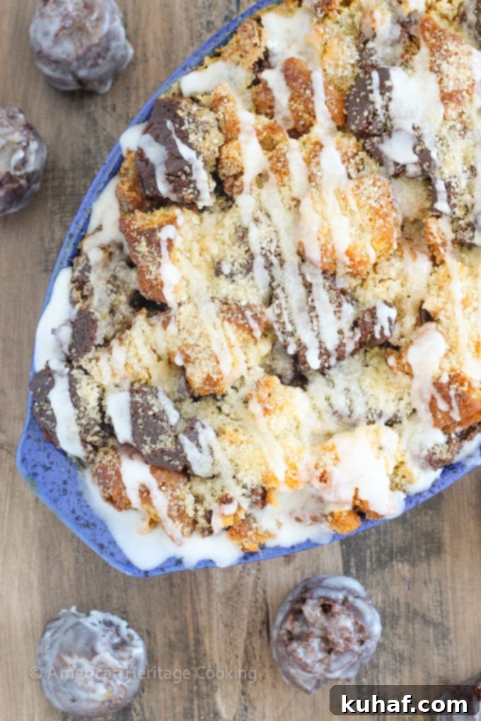 This Coffee Donut Bread Pudding takes everything you love about breakfast and bakes it into one easy dish! Cake donuts baked in a coffee custard for the perfect addition to brunch! A close-up of the crispy, glazed top of the coffee donut bread pudding.