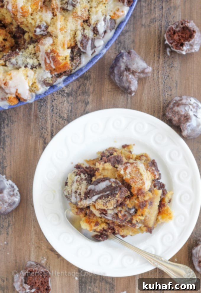 This Coffee Donut Bread Pudding takes everything you love about breakfast and bakes it into one easy dish! Cake donuts baked in a coffee custard for the perfect addition to brunch! A close-up shot of the coffee donut bread pudding, with a drizzle of glaze.
