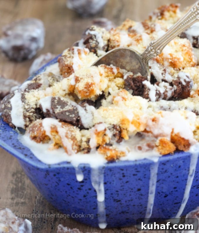 This Coffee Donut Bread Pudding takes everything you love about breakfast and bakes it into one easy dish! Cake donuts baked in a coffee custard for the perfect addition to brunch! A close-up of a serving of coffee donut bread pudding, showing its soft interior and glistening glaze.