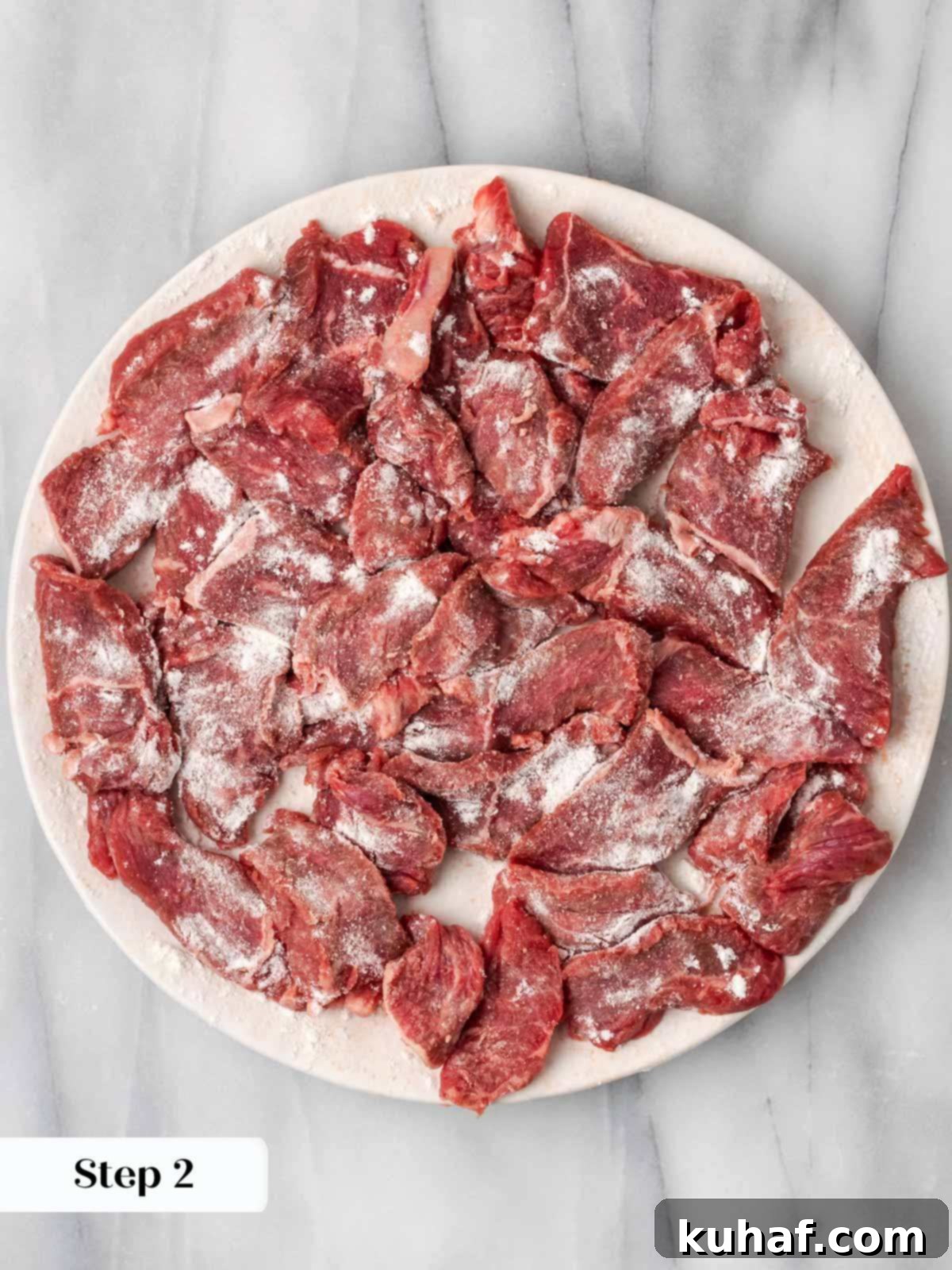 Floured beef sirloin strips ready for searing.
